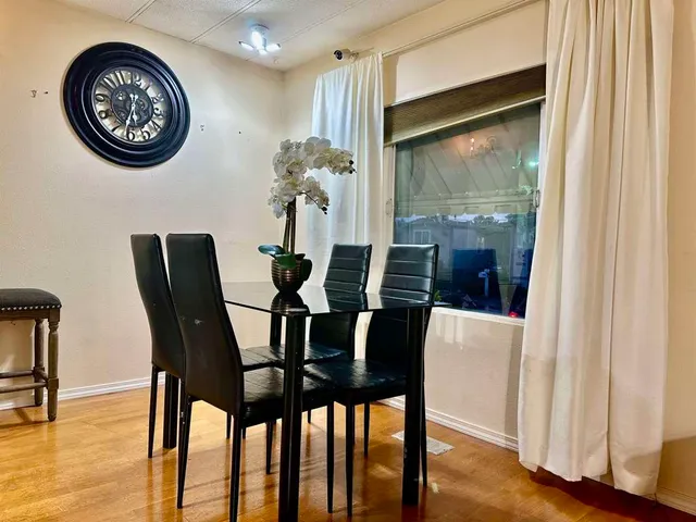 a view of a dining room with furniture and wooden floor
