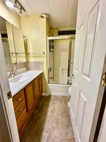 a bathroom with a sink a mirror and a shower