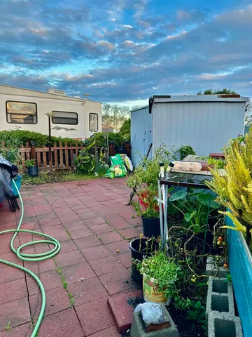 a backyard of a house with lots of green space and outdoor seating