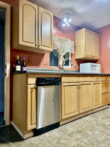 a kitchen with stainless steel appliances granite countertop a sink and cabinets