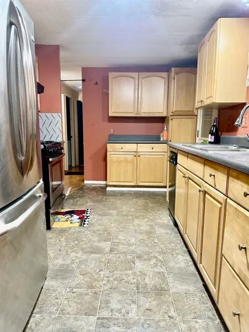 a kitchen with stainless steel appliances granite countertop a sink stove and cabinets