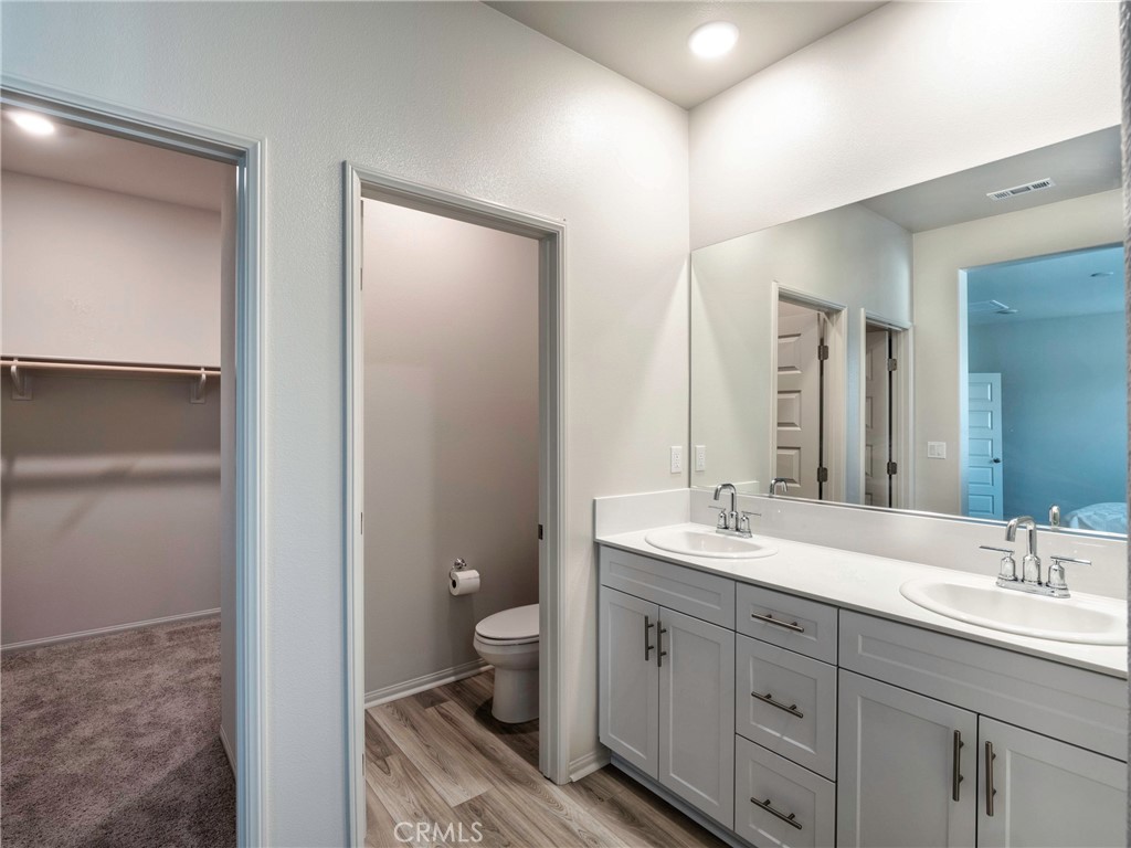 40336 Birchfield Drive Temecula, CA 92591 - Photo 22 of 39 a spacious bathroom with a double vanity sink a mirror and a toilet