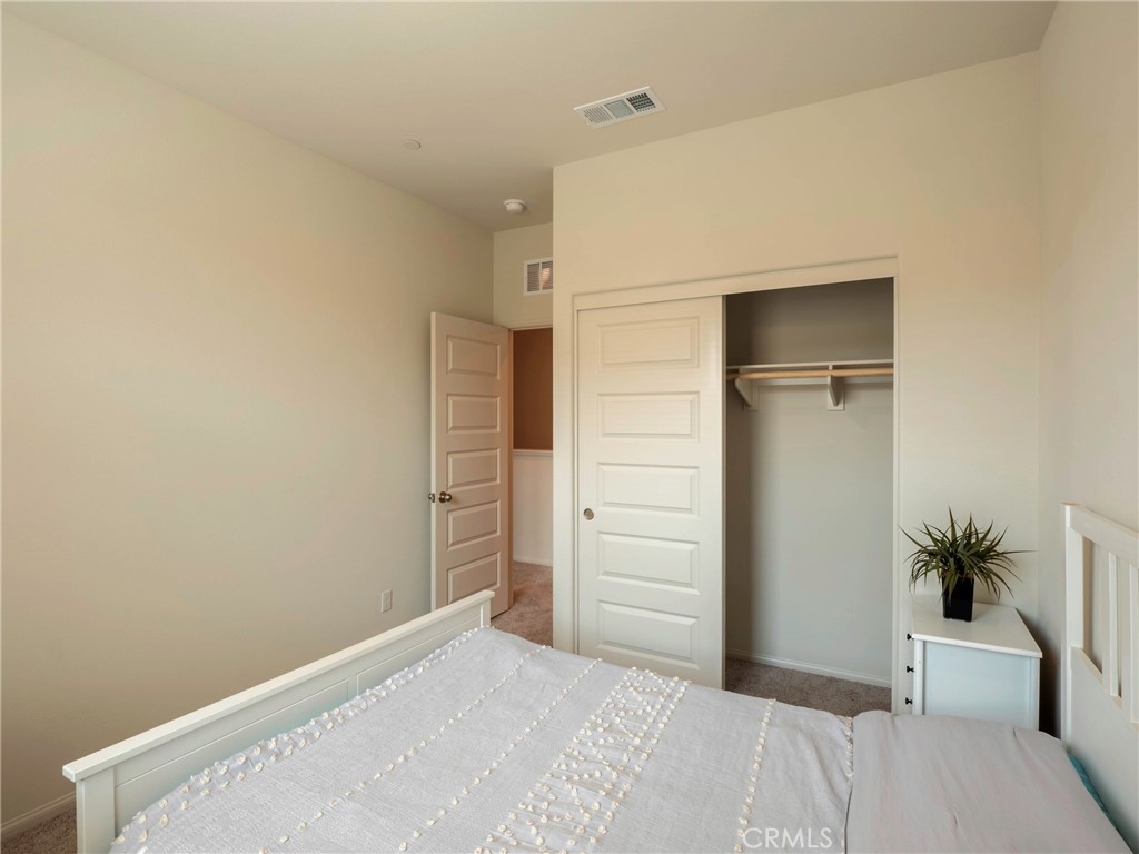 40336 Birchfield Drive Temecula, CA 92591 - Photo 26 of 39 a bedroom with a bed and a potted plant