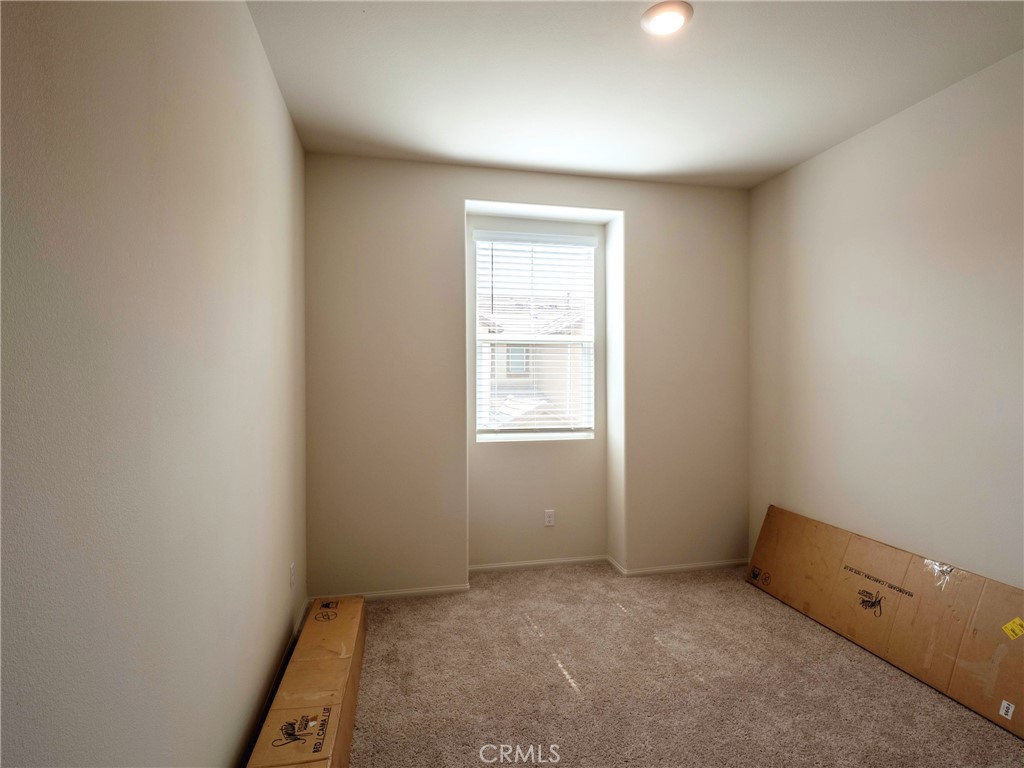 40336 Birchfield Drive Temecula, CA 92591 - Photo 27 of 39 an empty room with a chair and a window