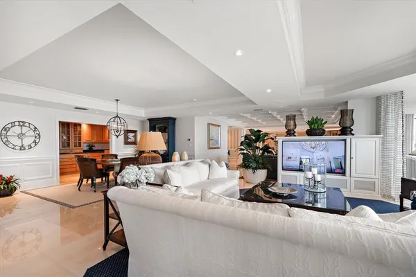 a living room with lots of furniture and kitchen view