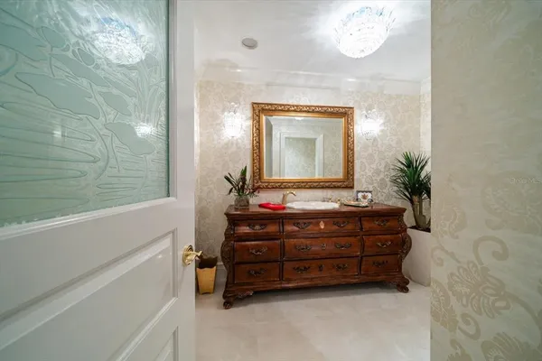 a large white kitchen with stainless steel appliances granite countertop a refrigerator and a white cabinets