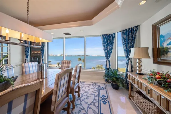 a living room with furniture kitchen view and a large window