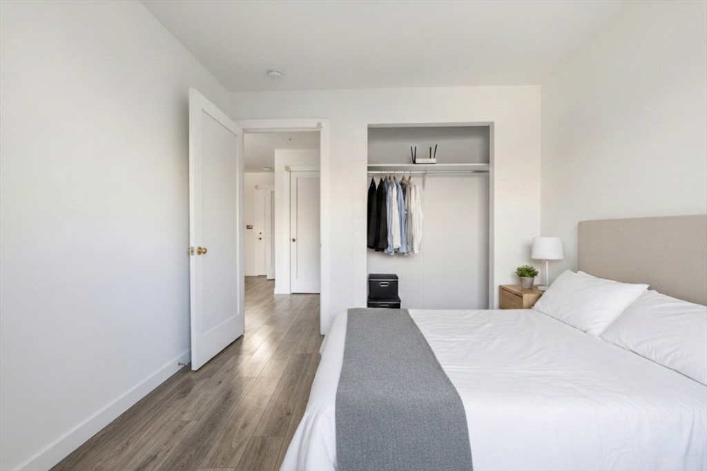 1035 Commonwealth Avenue, Unit 504 Boston, MA 02215 - Photo 8 of 18 a bedroom with a bed and a refrigerator