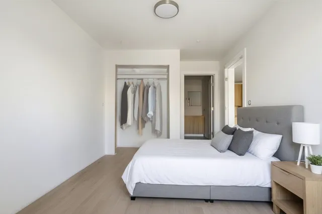 a bedroom with a bed and a lamp