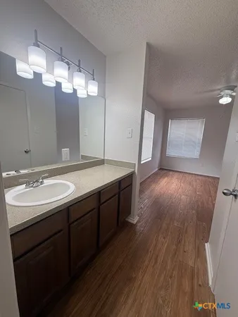 a bathroom with a double vanity sink and a mirror
