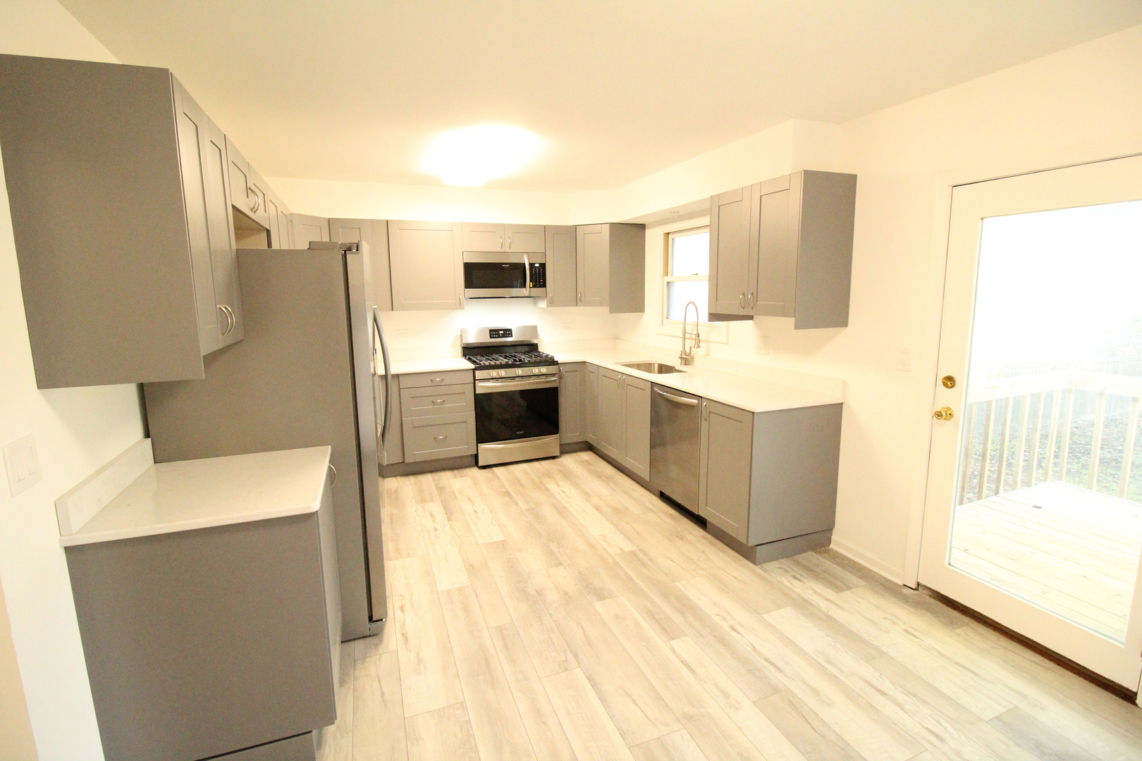 3 Deerpath Road Lake In The Hills, IL 60156 - Photo 2 of 22 a large white kitchen with a large window