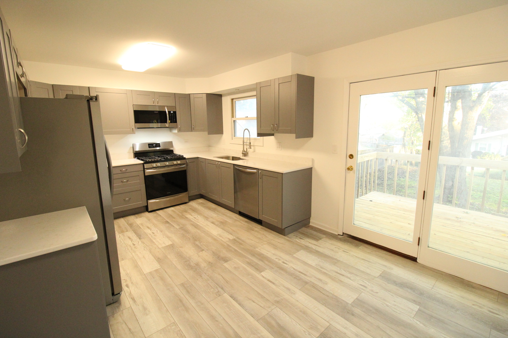 3 Deerpath Road Lake In The Hills, IL 60156 - Photo 4 of 22 a large kitchen with stainless steel appliances granite countertop a stove a sink and a refrigerator
