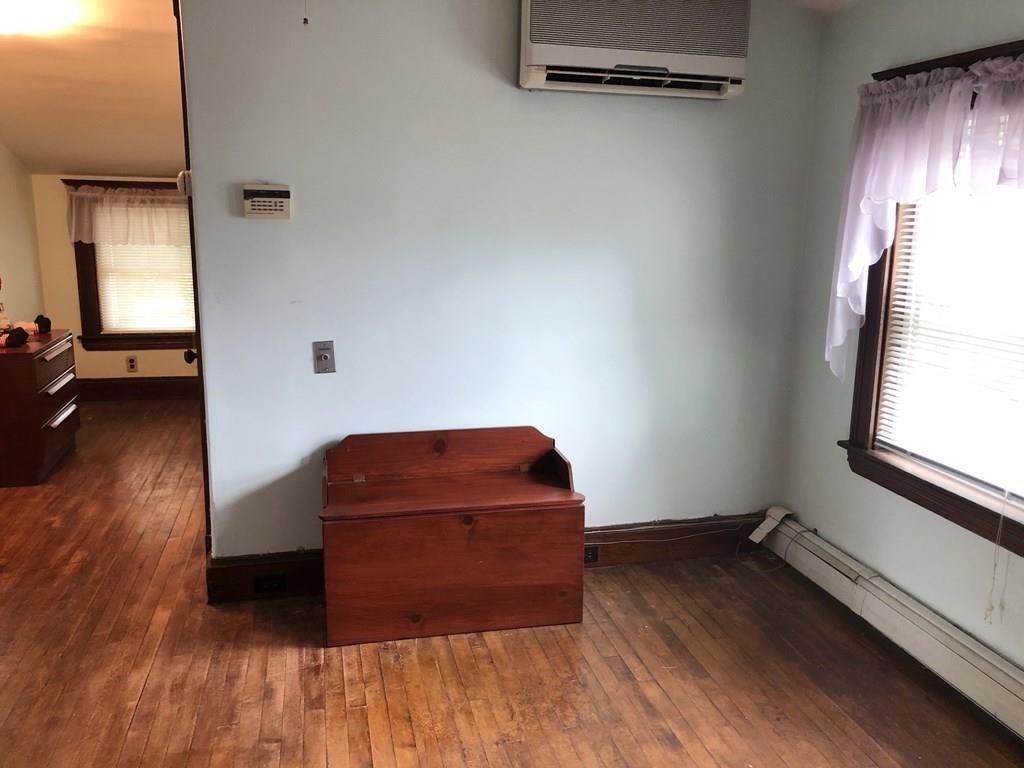 16 Bluff Road Weymouth, MA 02191 - Photo 12 of 20 an empty room with wooden floor and windows