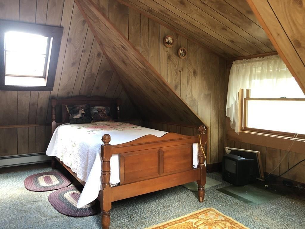 16 Bluff Road Weymouth, MA 02191 - Photo 15 of 20 a bed sitting in a room next to a window