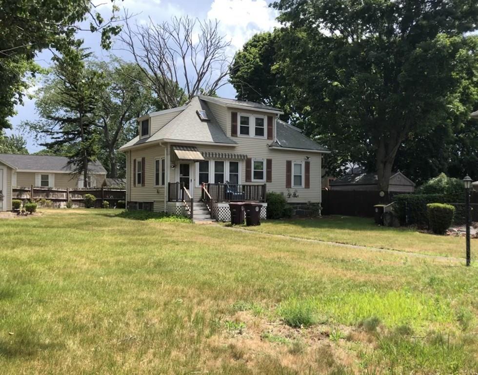 16 Bluff Road Weymouth, MA 02191 - Photo 20 of 20 a front view of a house with a yard table and chairs