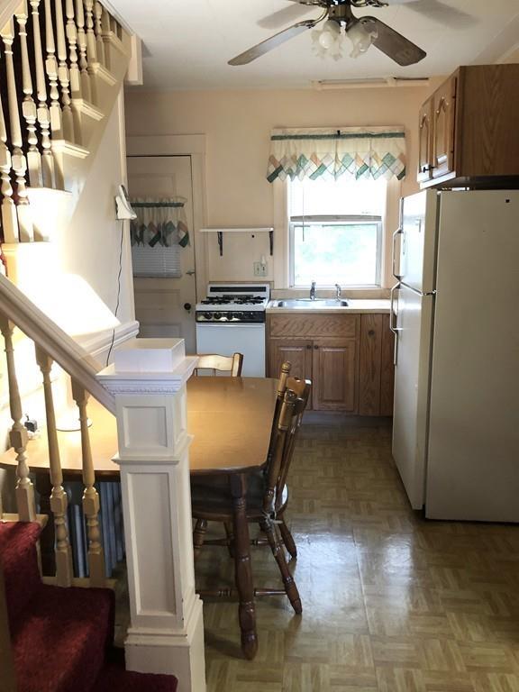 16 Bluff Road Weymouth, MA 02191 - Photo 5 of 20 a kitchen with refrigerator a stove a sink and chairs
