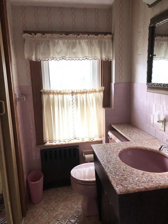 16 Bluff Road Weymouth, MA 02191 - Photo 10 of 20 a bathroom with a granite countertop sink toilet a mirror and window