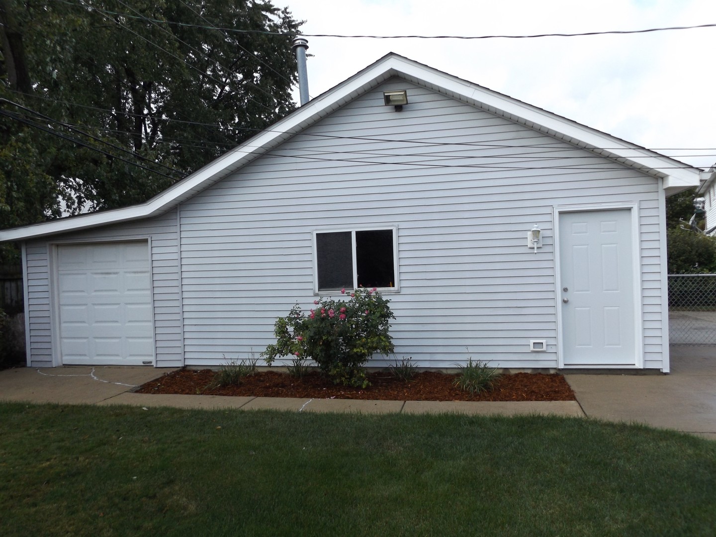 6953 Olympic Drive Bridgeview, IL 60455 - Photo 13 of 33 a view of a white house next to a yard