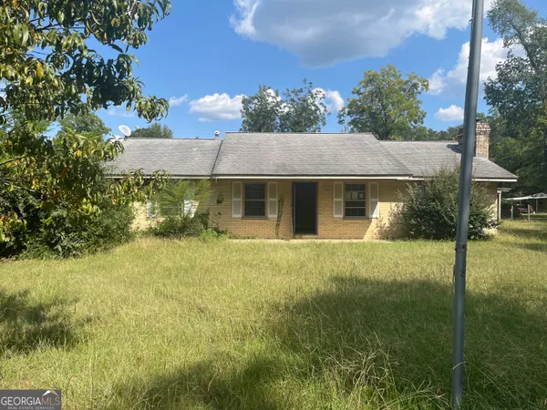 a view of a house with pool and garden