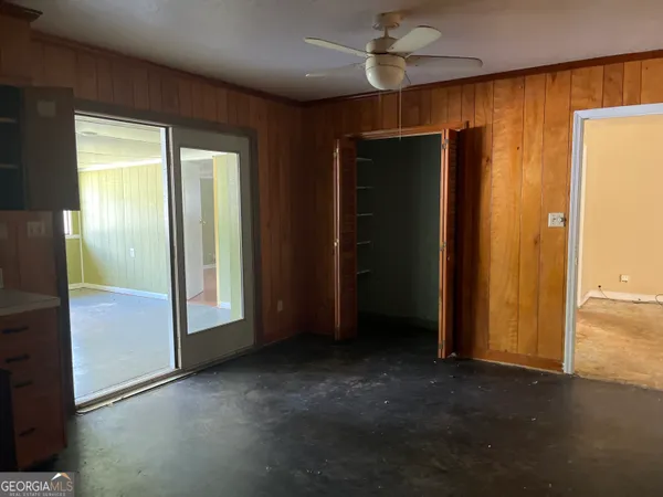 an empty room with windows and closet
