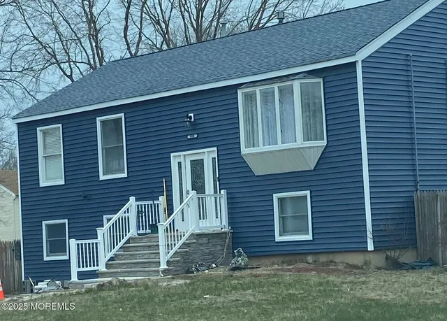a view of a house with patio and garden
