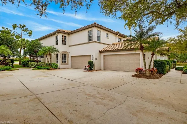 a view of a house with a yard and garage
