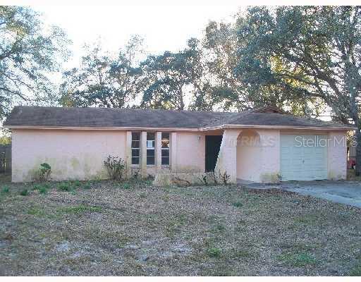 1479 Larkin Road Spring Hill, FL 34608 - Photo 1 of 1 front view of a house with a dry yard