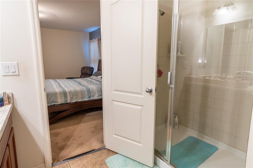 4563 Orchard Grove Road St. Cloud, FL 34772 - Photo 22 of 51 a en suite bathroom with a sink and a mirror