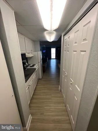 a view of a hallway with wooden floors and stairs