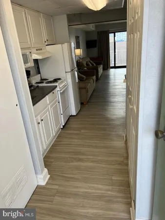 a view of a kitchen from a hallway