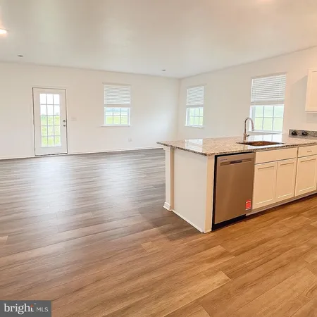 a kitchen with stainless steel appliances granite countertop a white cabinets and window