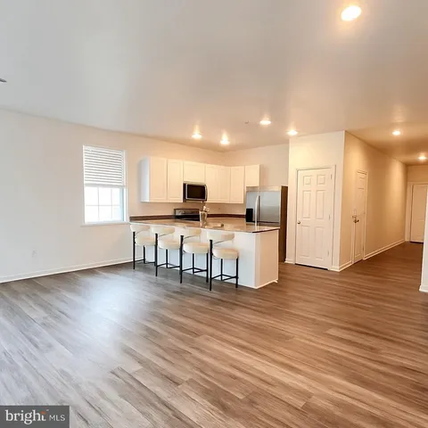 a view of a kitchen with dining table and chairs