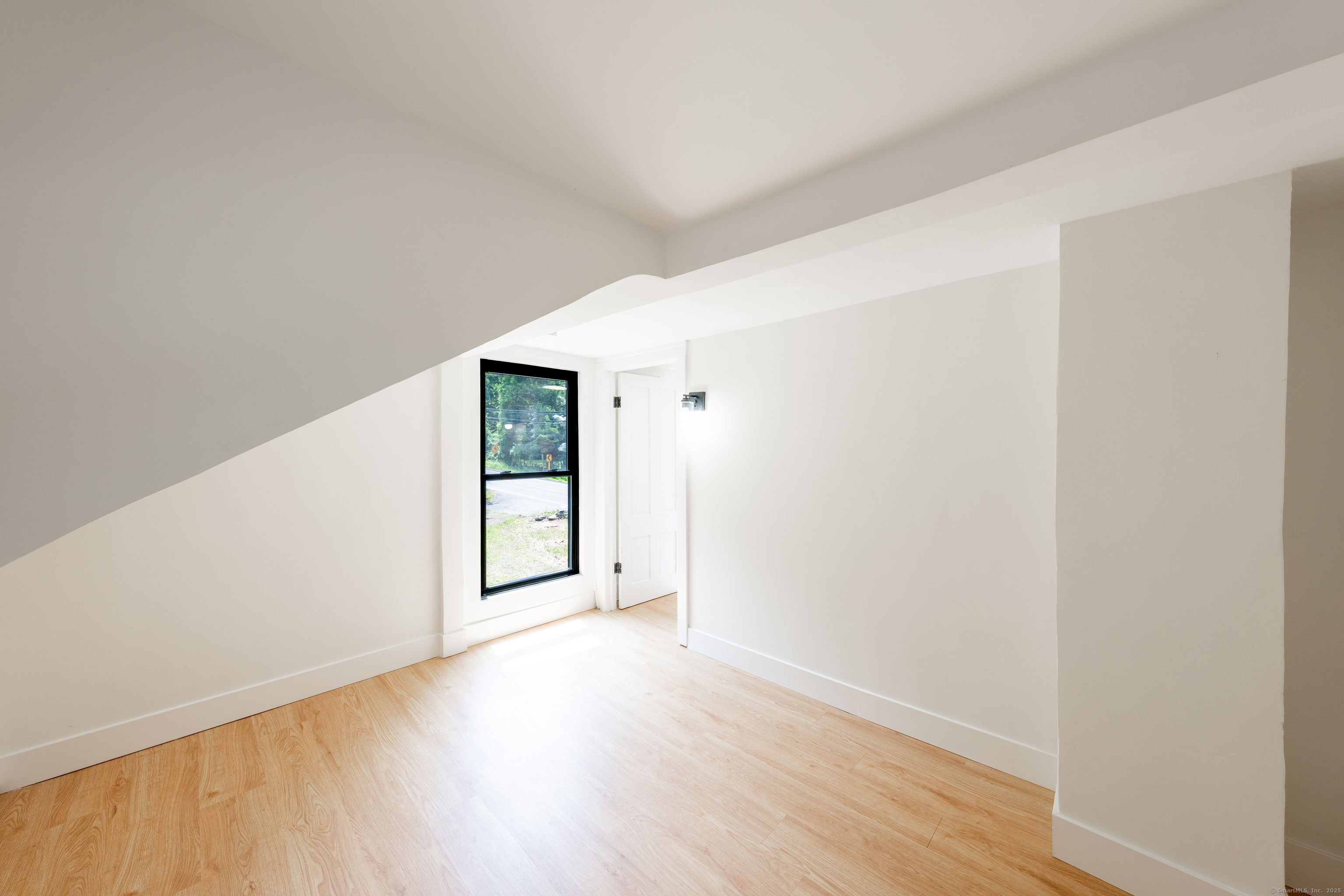 219 Redding Road Redding, CT 06896 - Photo 15 of 27 a view of an empty room with wooden floor and a window