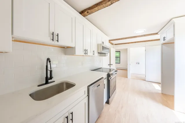 a kitchen with a sink stove and cabinets