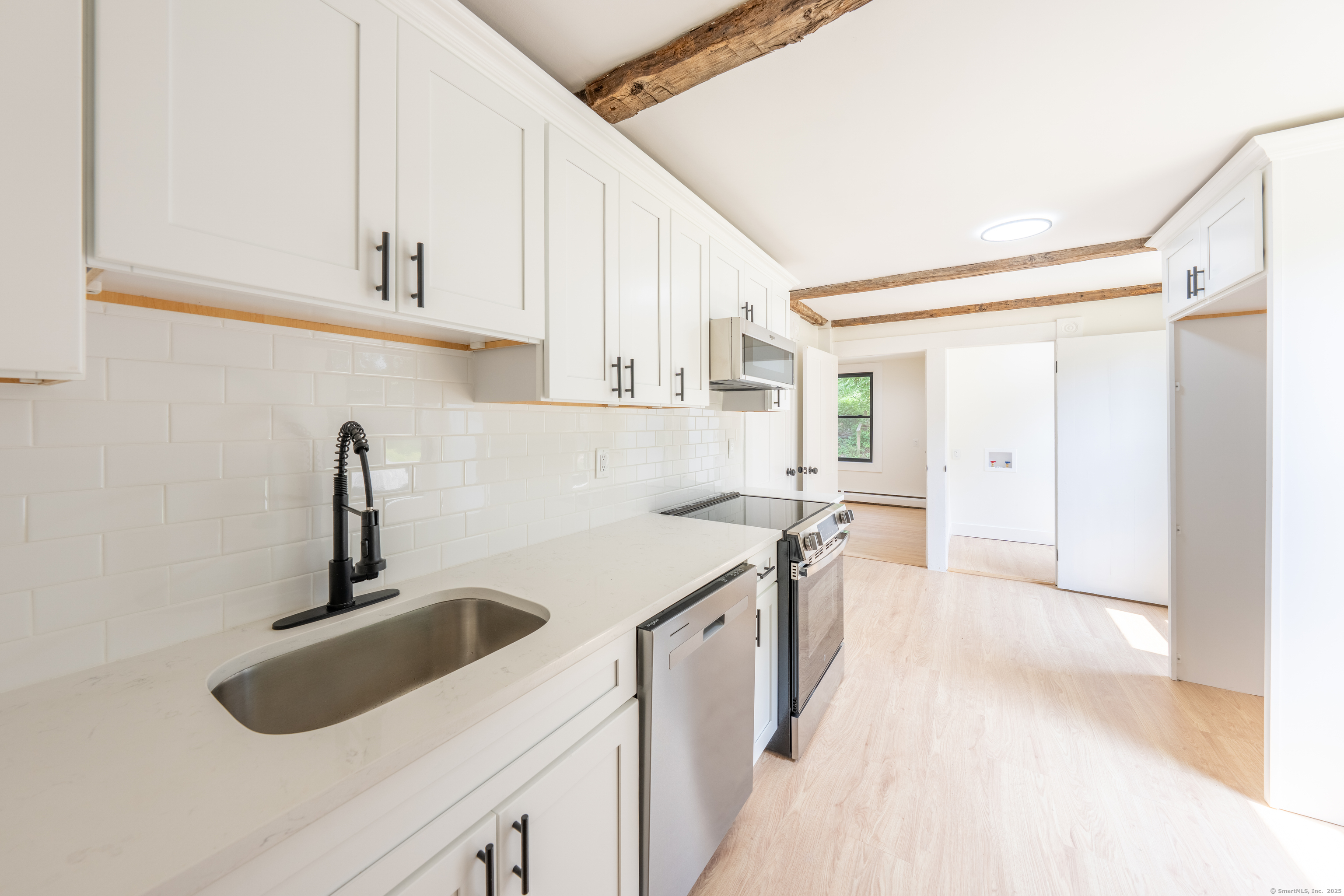 219 Redding Road Redding, CT 06896 - Photo 2 of 27 a kitchen with a sink stove and cabinets
