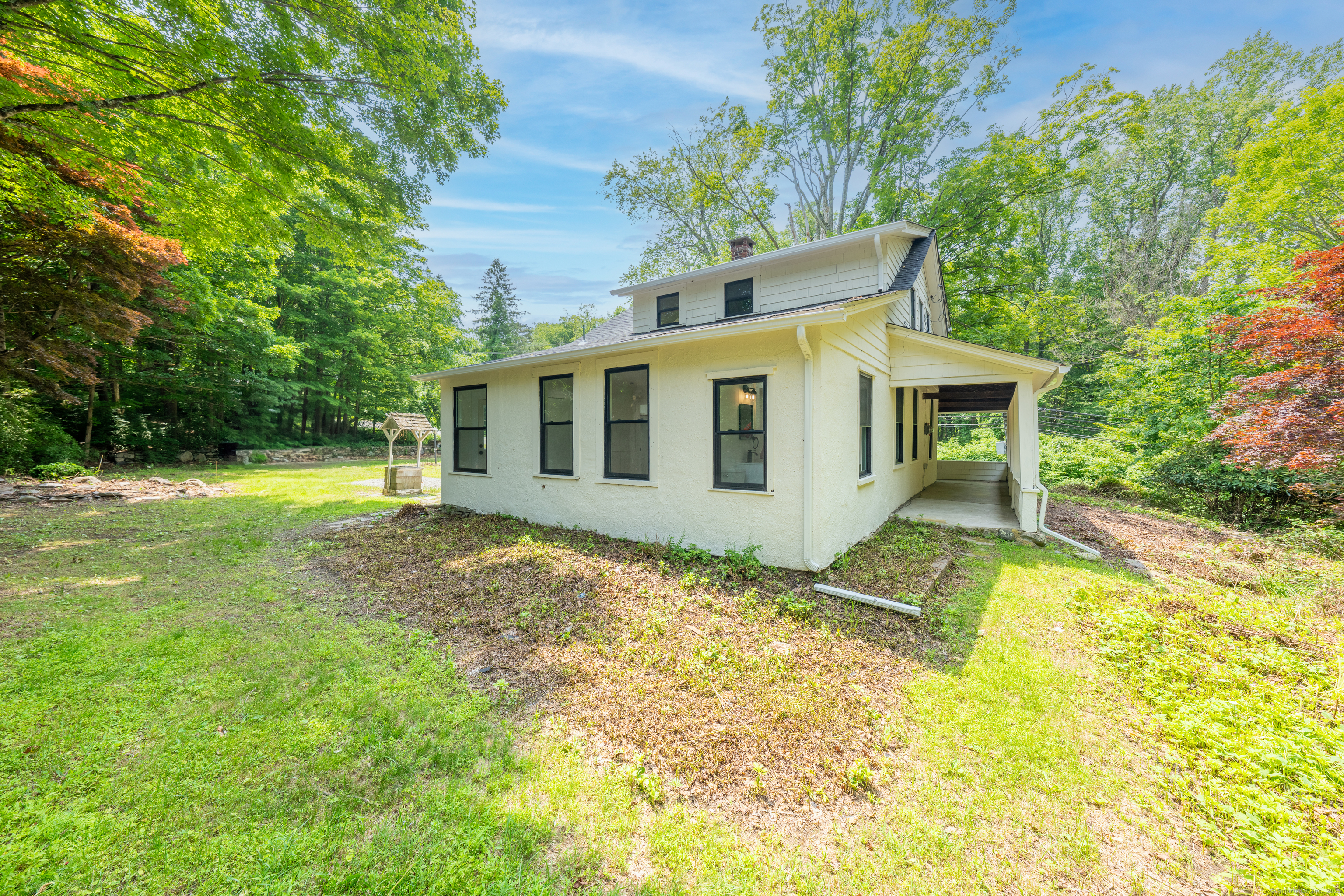 219 Redding Road Redding, CT 06896 - Photo 26 of 27 a view of a house with a yard