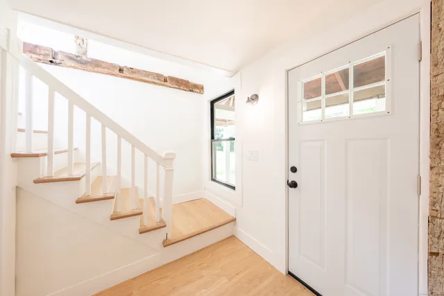 a view of entryway and hall with wooden floor