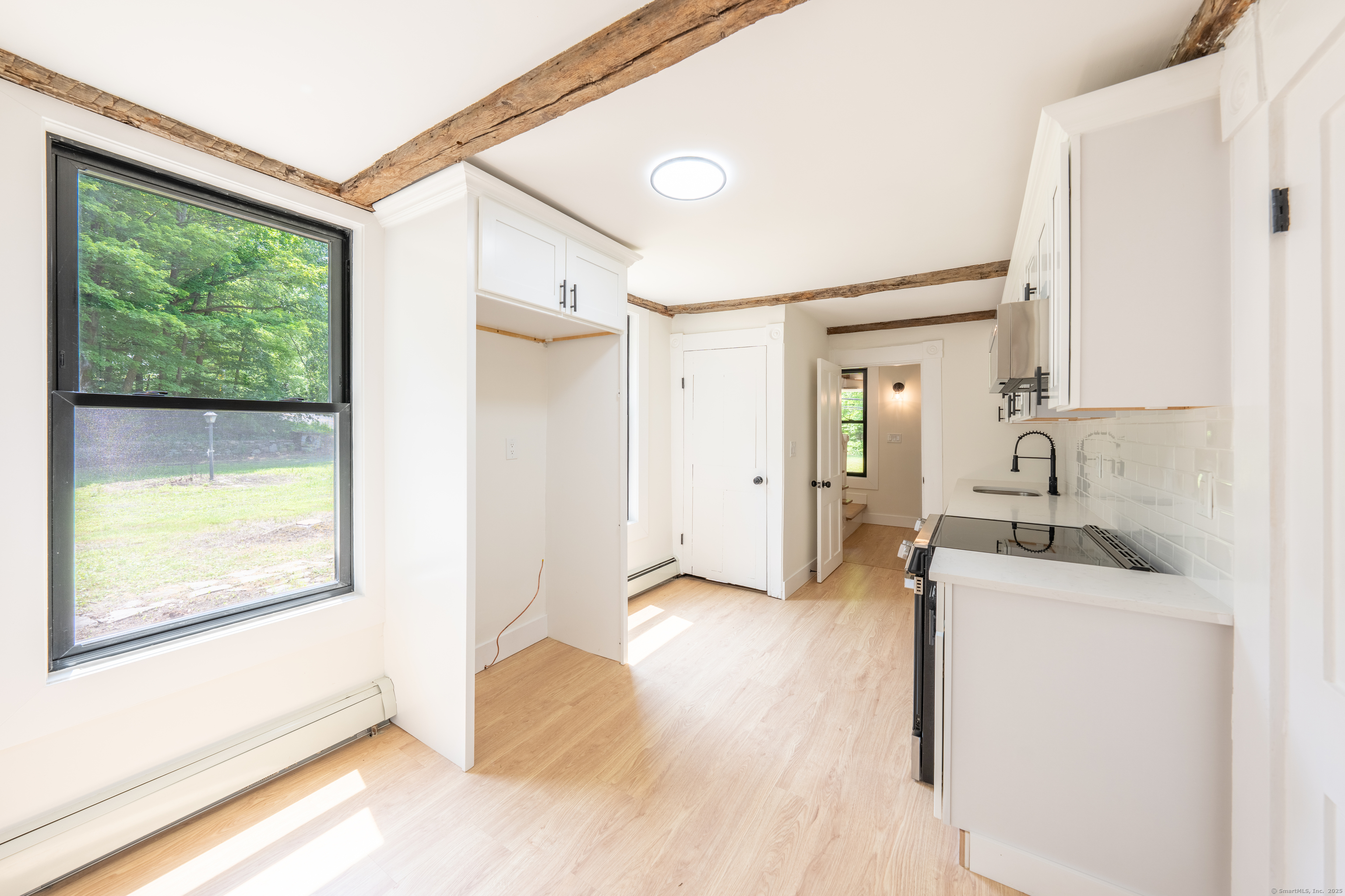 219 Redding Road Redding, CT 06896 - Photo 5 of 27 a view of a kitchen cabinets and a wooden floor
