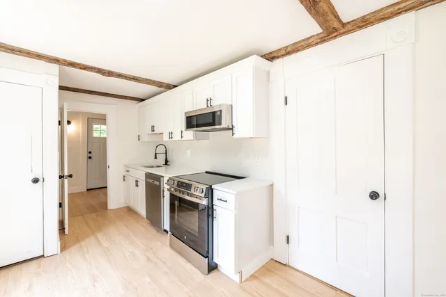 a kitchen with a stove a sink and a refrigerator