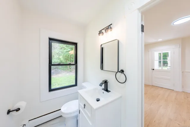 a bathroom with a toilet sink shower and mirror