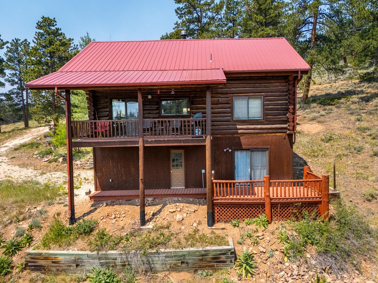 296 Caddo Road Red Feather Lakes, CO 80545 - Photo 32 of 50 View of the back of the cabin and two levels of decks.