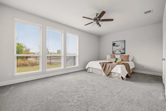 a bedroom with a bed and window