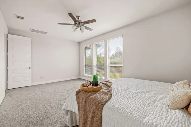 a bedroom with a large bed and a window
