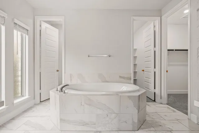 a bathroom with a bathtub and shower