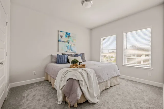 a bed room with a bed and a window