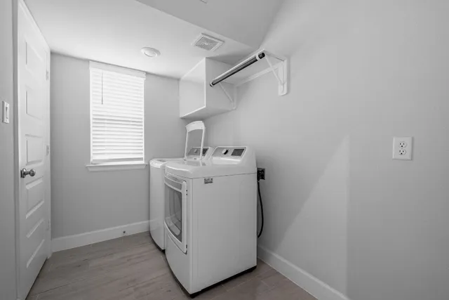 a utility room with cabinets washer and dryer