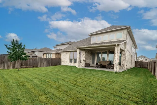a view of a house with a yard and porch