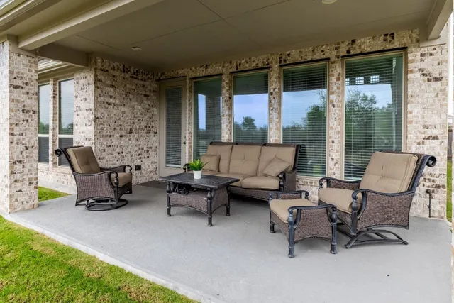 a building outdoor space with patio furniture and a couch