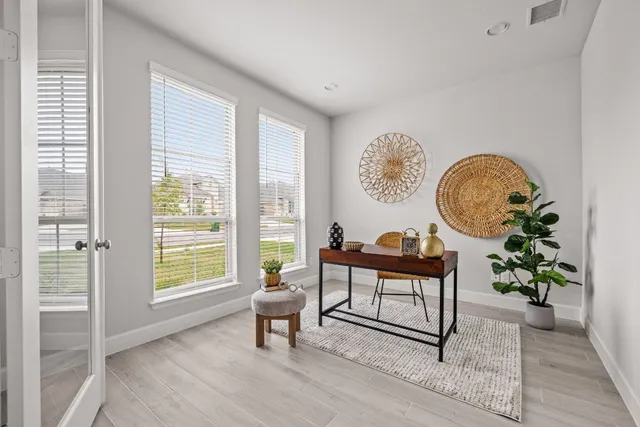 a living room with furniture a table and a potted plant