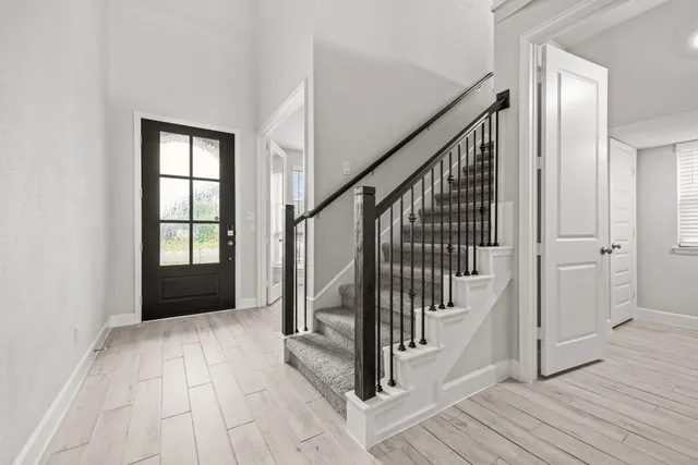 a view of an entryway with wooden floor and stairs